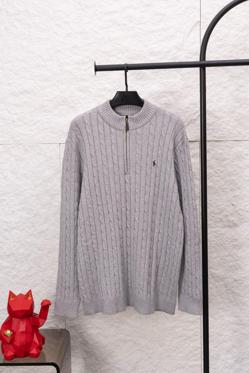 Light gray cable-knit quarter-zip sweater with ribbed stand collar