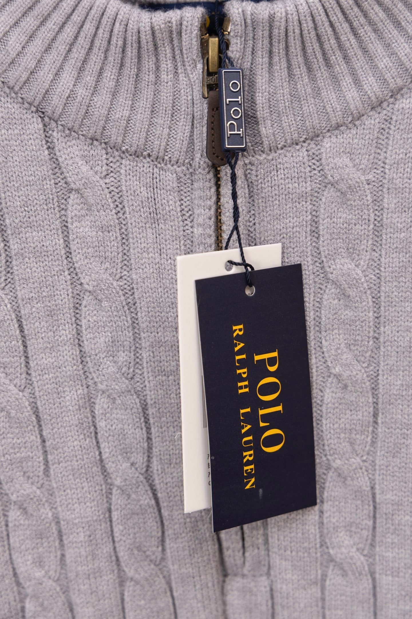 Light gray knit sweater showing Polo Ralph Lauren label on zipper placket