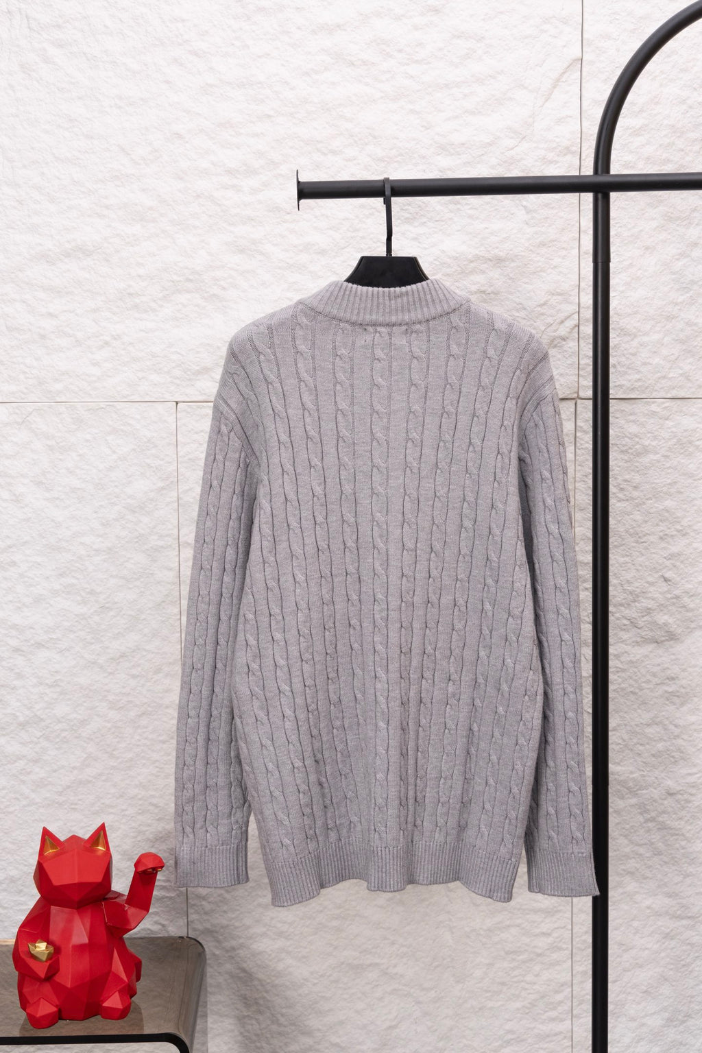 Light gray cable-knit quarter-zip sweater back view with ribbed stand collar