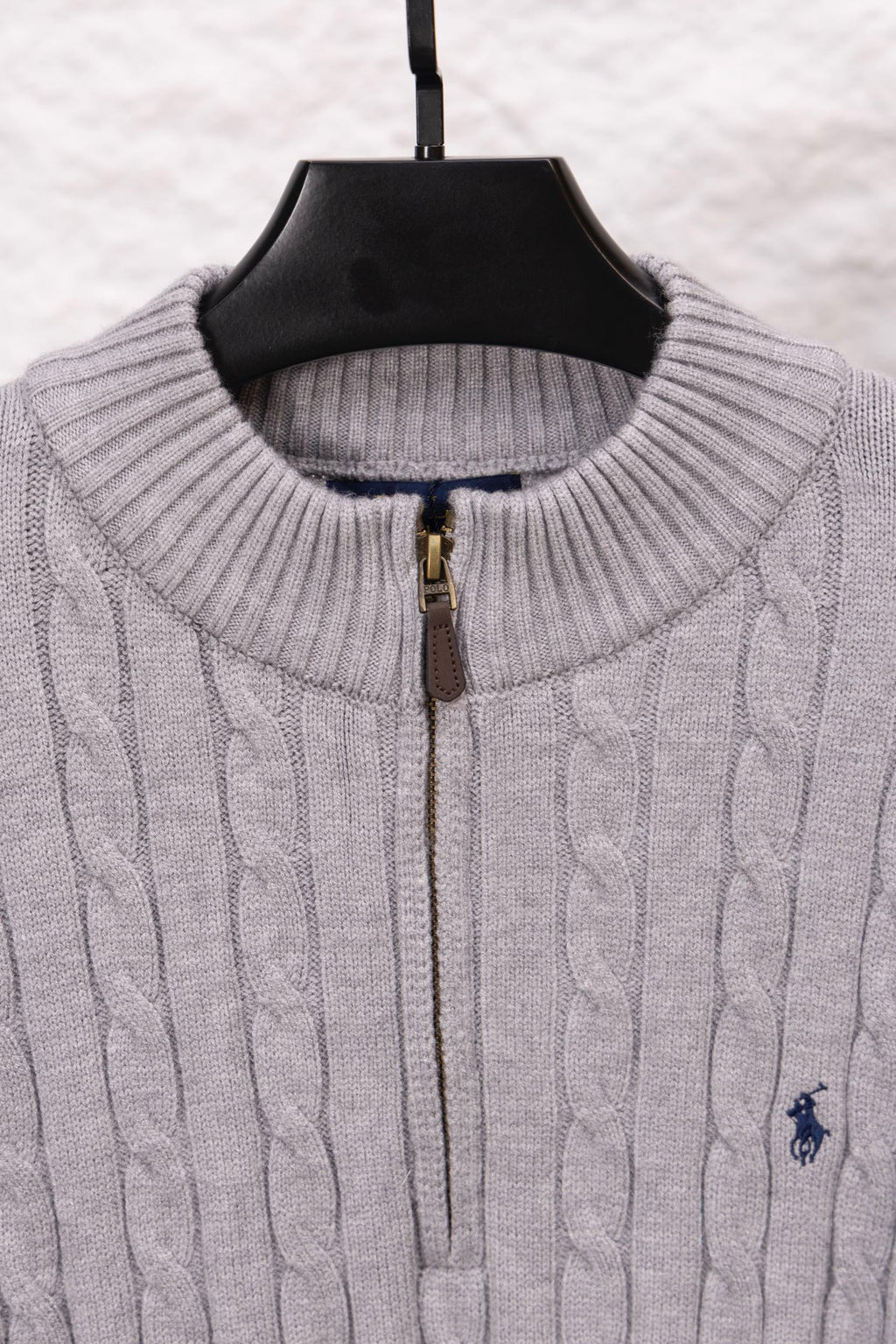 Light gray ribbed stand-collar sweater with gold zipper and polo logo