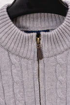 Light gray quarter-zip sweater with gold zipper and ribbed neckline