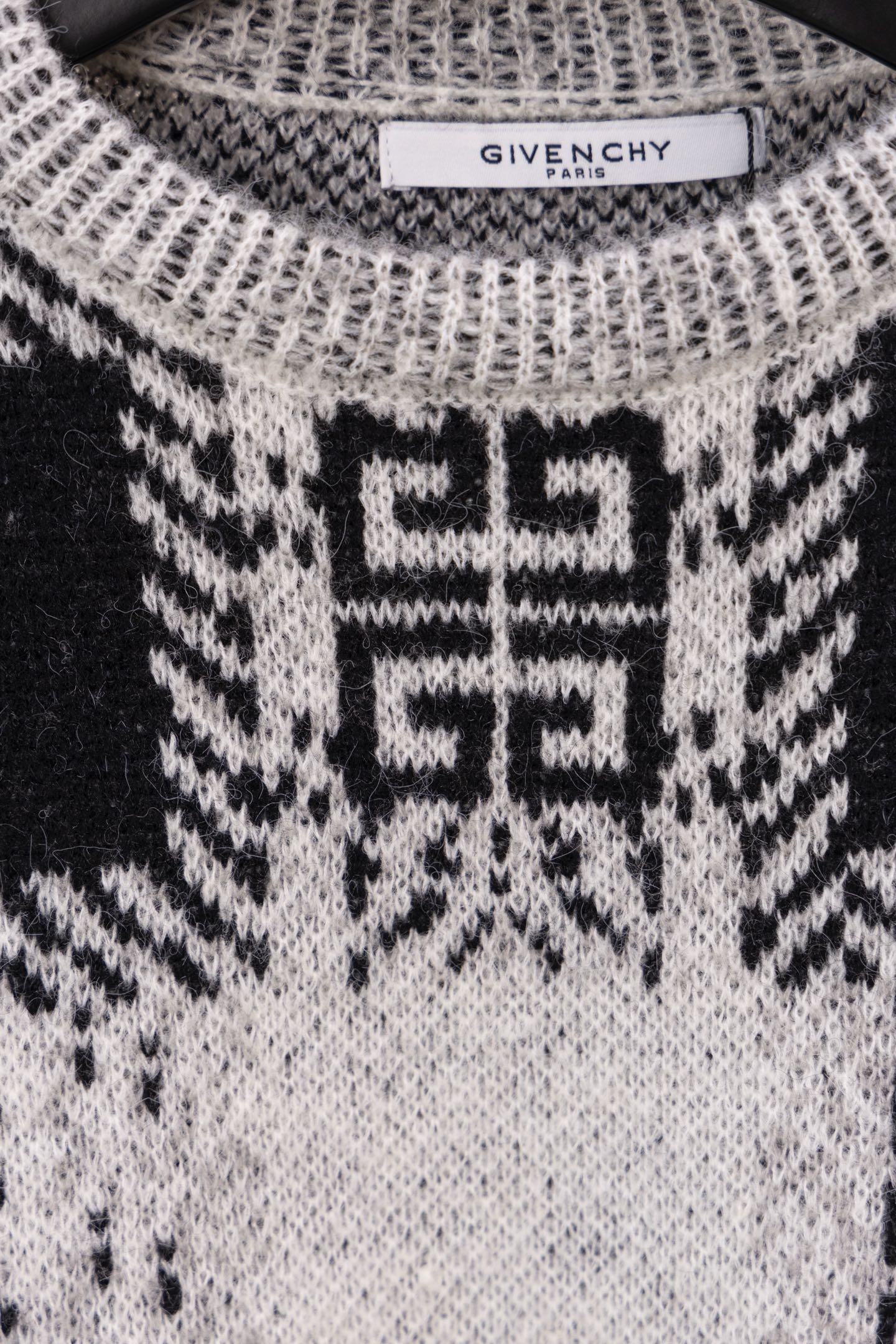 Givenchy knit sweater front close-up with black and white geometric motif on chest