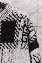 Givenchy knit sweater shoulder and sleeve close-up with black and white geometric motif