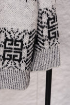 Givenchy knit sweater sleeve close-up in black and white geometric jacquard pattern