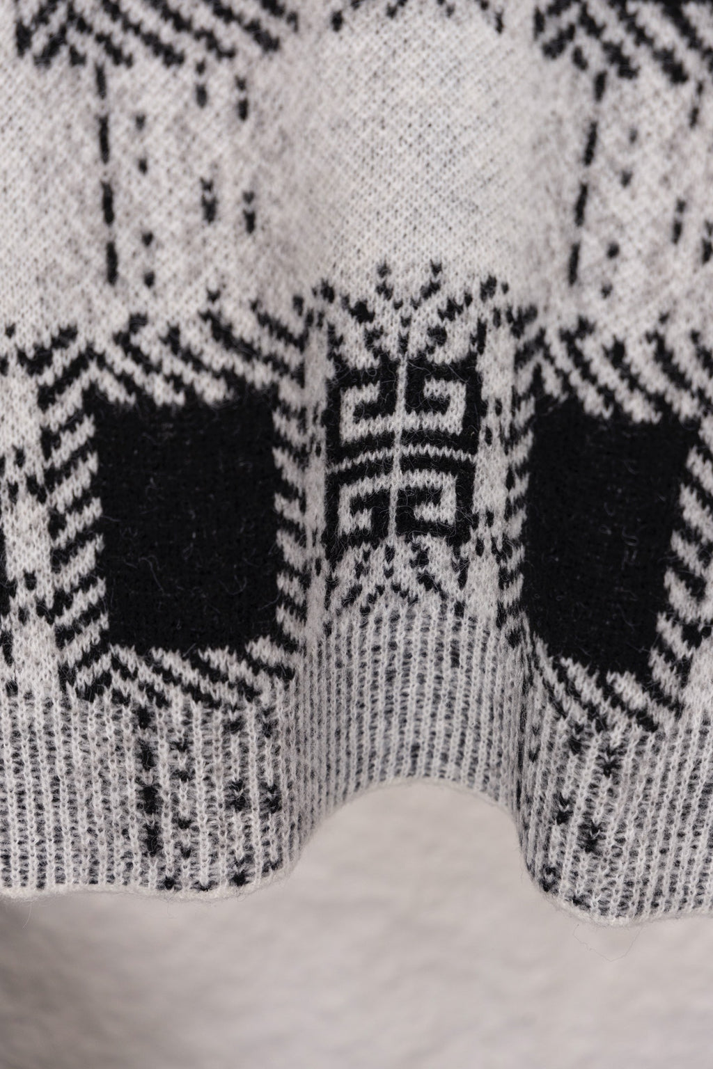 Givenchy knit sweater lower back close-up with black and white geometric pattern