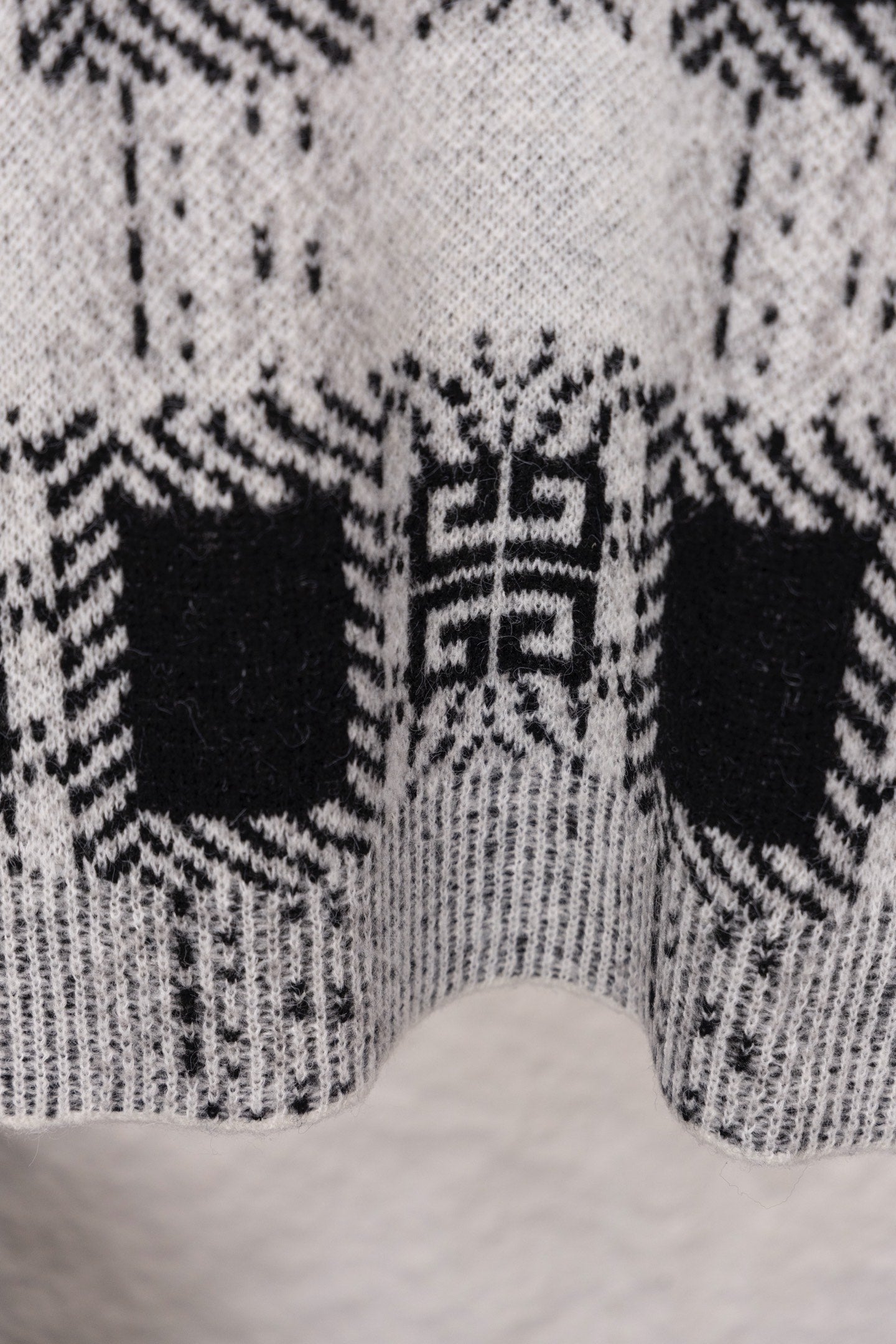 Givenchy knit sweater lower back close-up with black and white geometric pattern