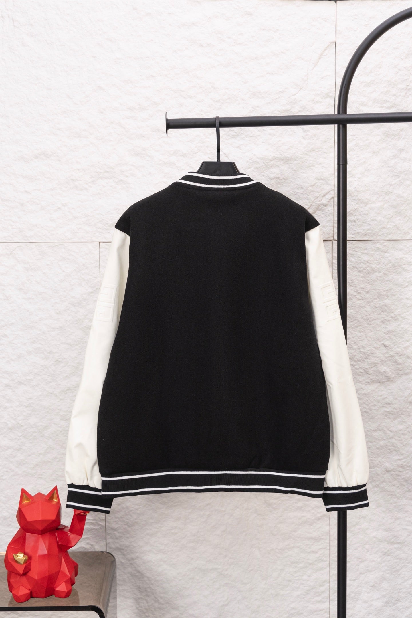 Givenchy black varsity jacket back view with white striped collar and cuffs