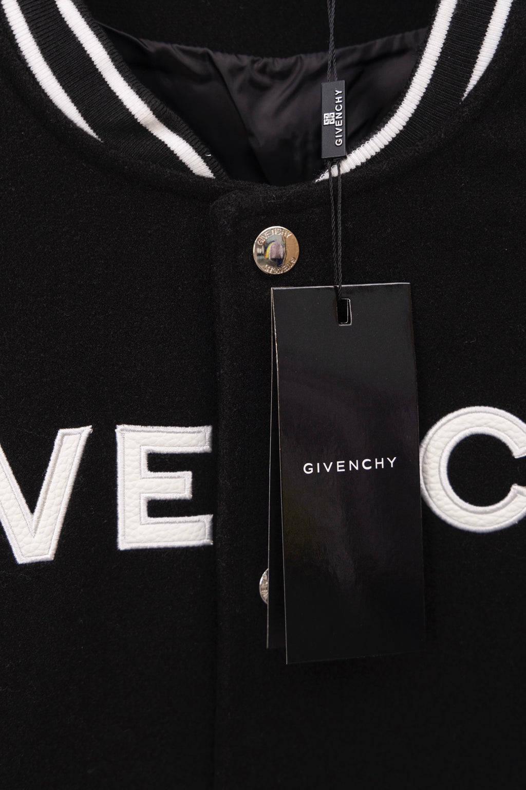 Givenchy black varsity jacket with GIVE NCHY front print and hanging tag