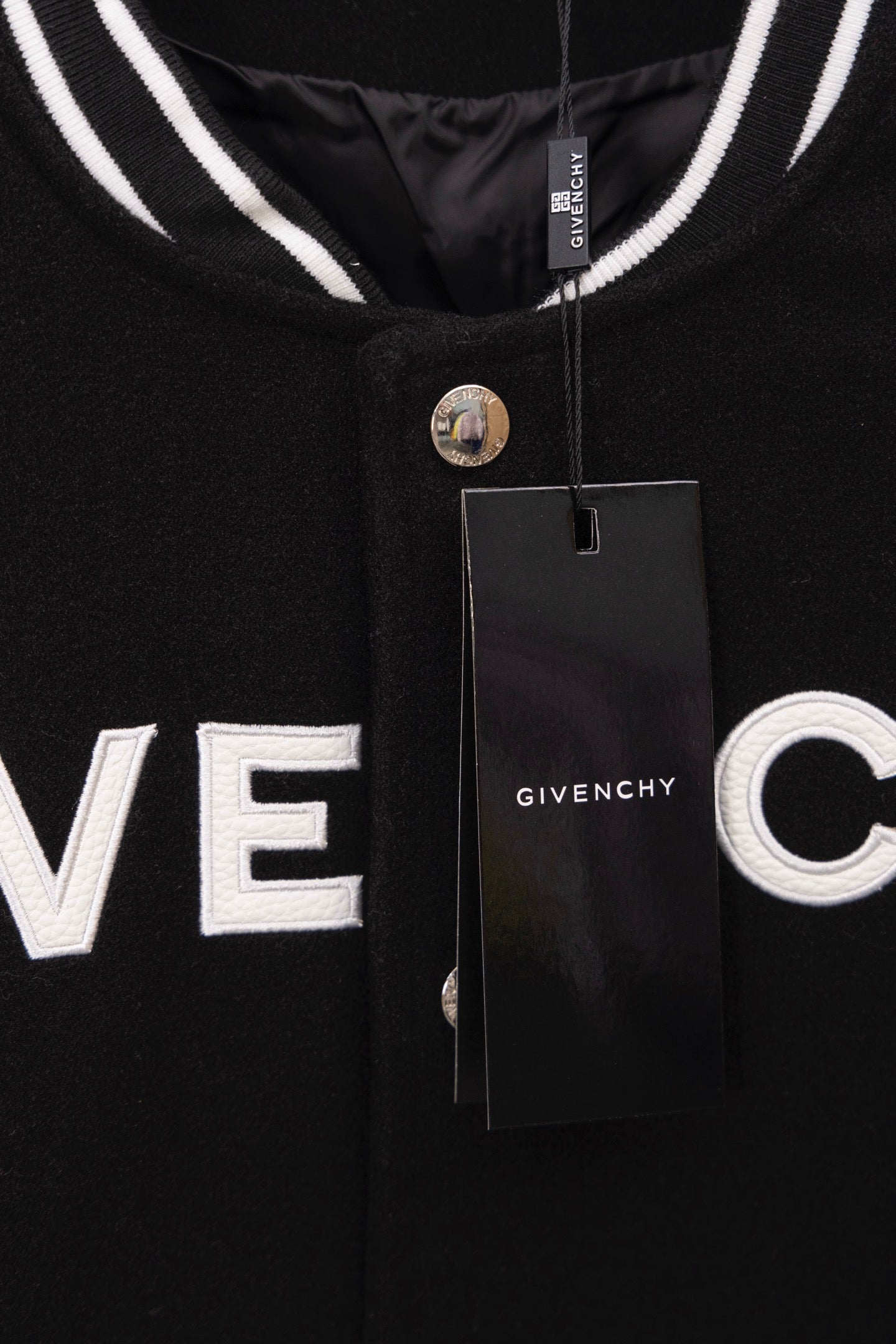 Givenchy black varsity jacket with GIVE NCHY front print and hanging tag