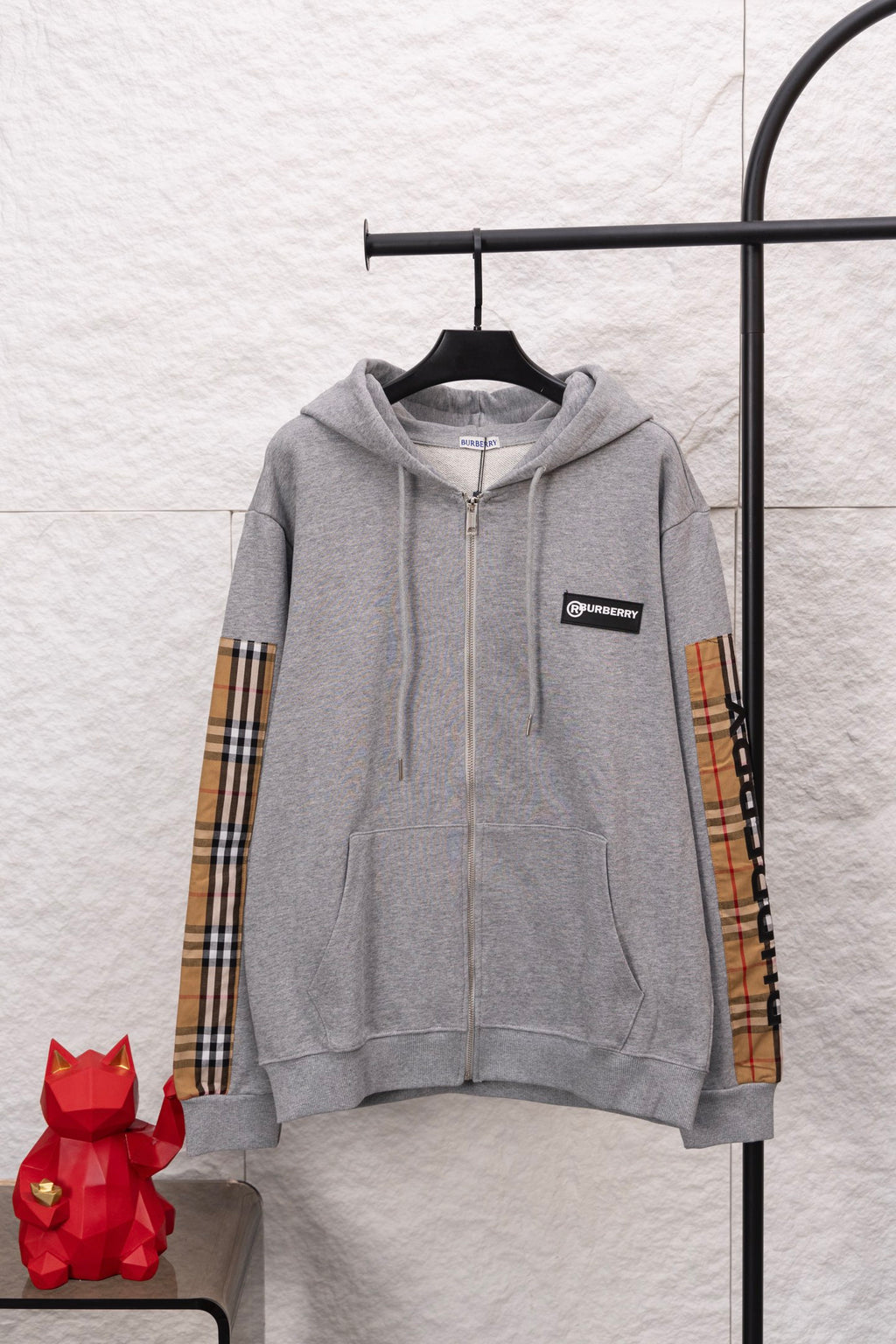 Burberry long zip-up hoodie in heather gray with hood and front zipper on hanger