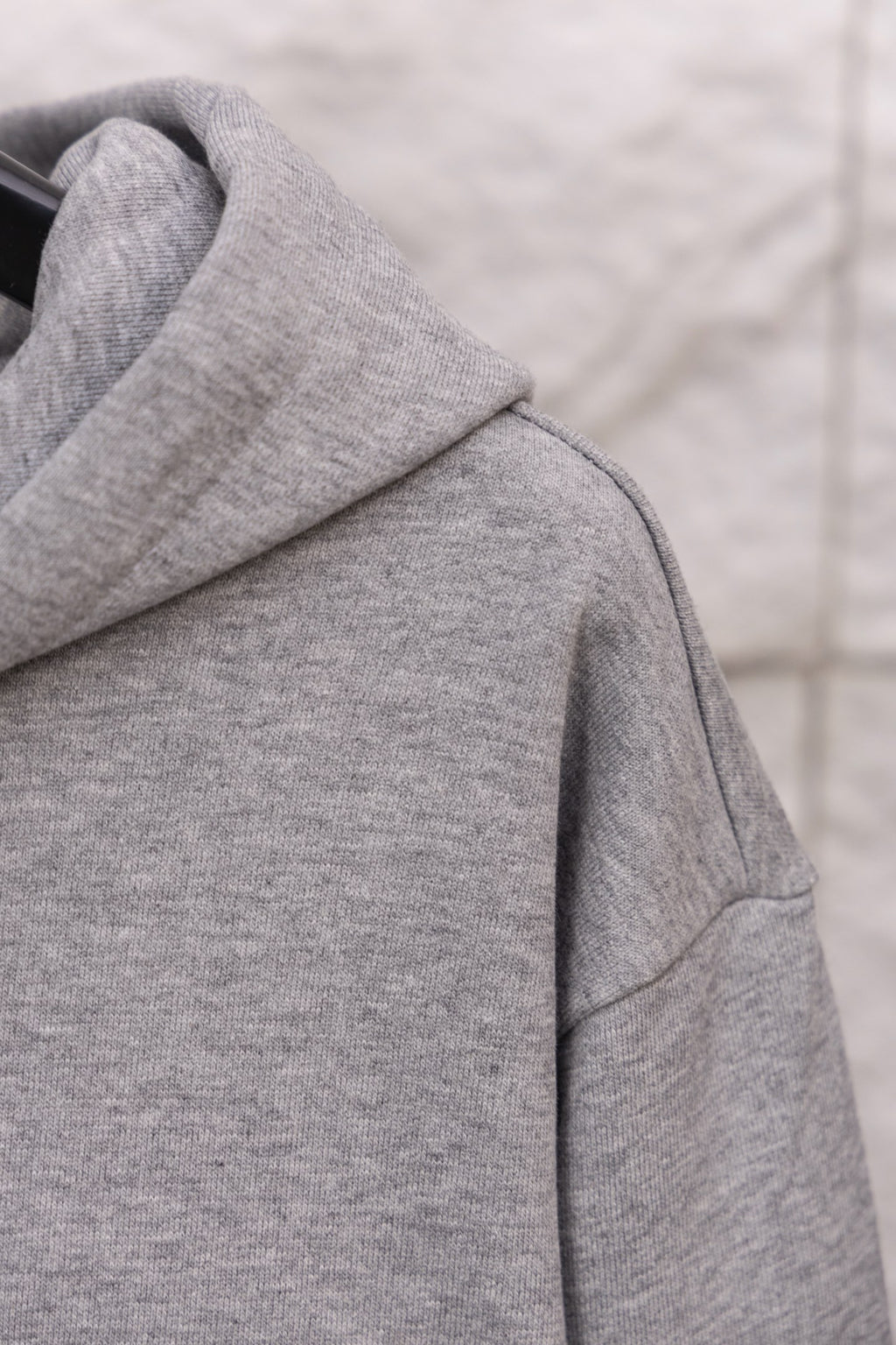 Heather gray hoodie shoulder and hood seam detail