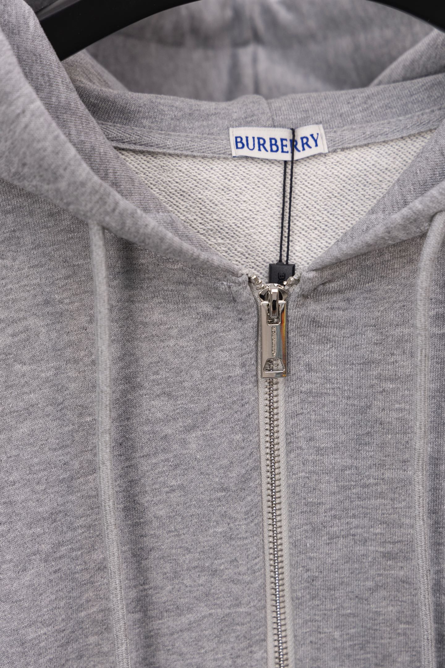 Burberry long zip-up hoodie close-up: hood lining and metal front zipper