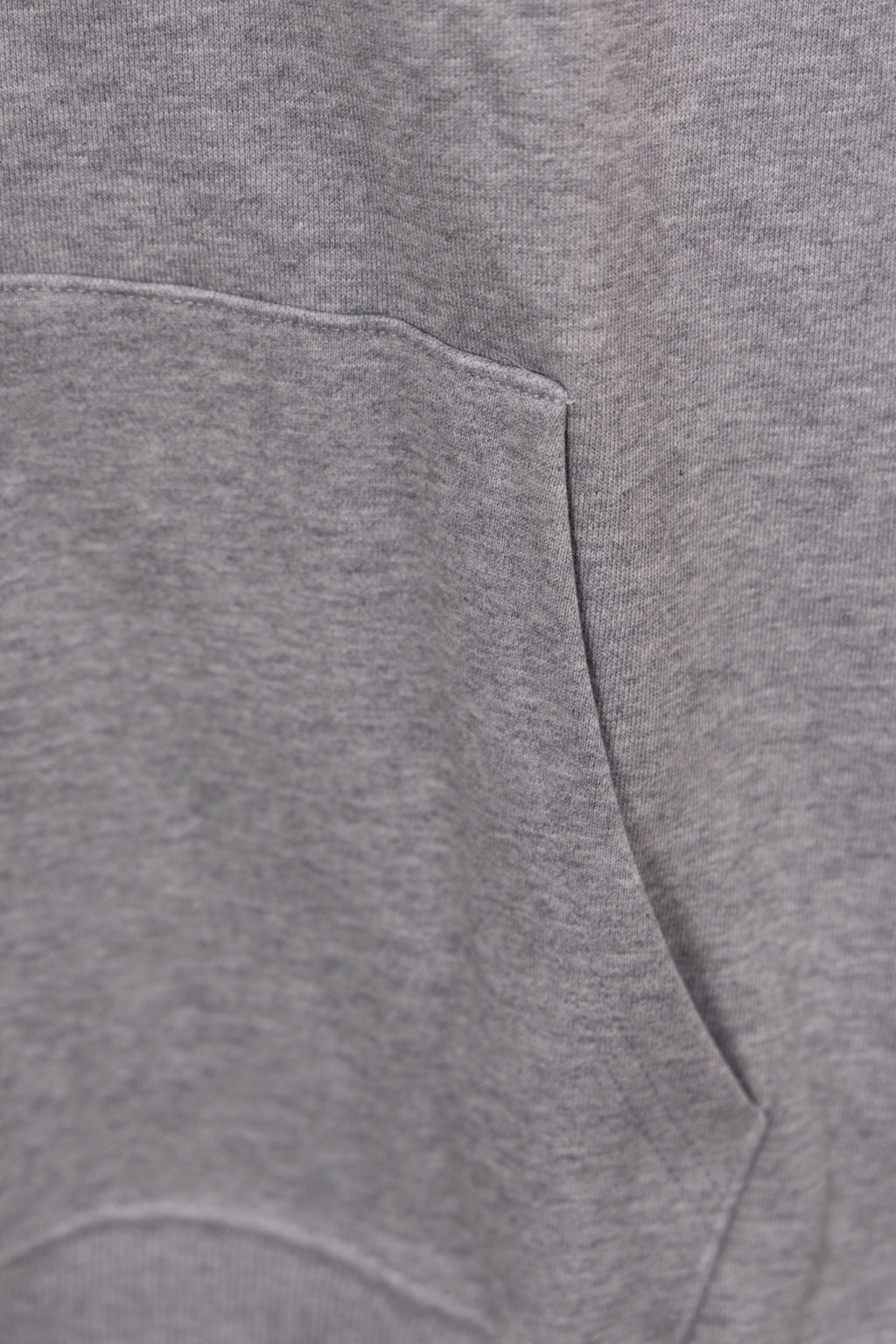 Heather gray hoodie front pocket and drawstring hem seam detail