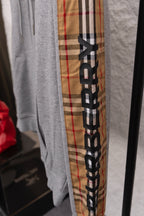 Grey long-sleeve sweatshirt with vertical check plaid panel and logo print