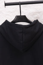 Black hoodie hood back with inner seam and drawstring ends on hanger