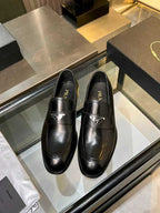 Prada black leather loafers with metal logo on the front, unisex