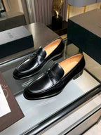 Black leather slip-on loafers with Dior monogram buckle and curved toe