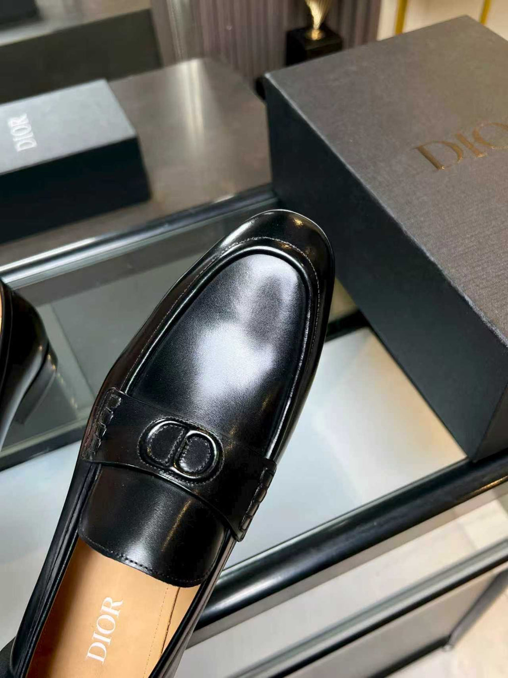Black leather loafer with Dior monogram buckle, side profile view