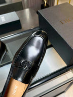 Black leather loafer with Dior monogram buckle, side profile view