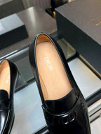 Black leather loafer showing tan insole with Dior text and front logo
