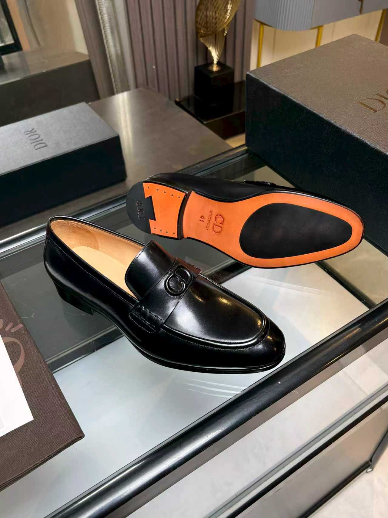 Black leather loafer with Dior monogram buckle and orange sole interior