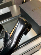 Black leather dress loafer with Dior monogram buckle, close side view