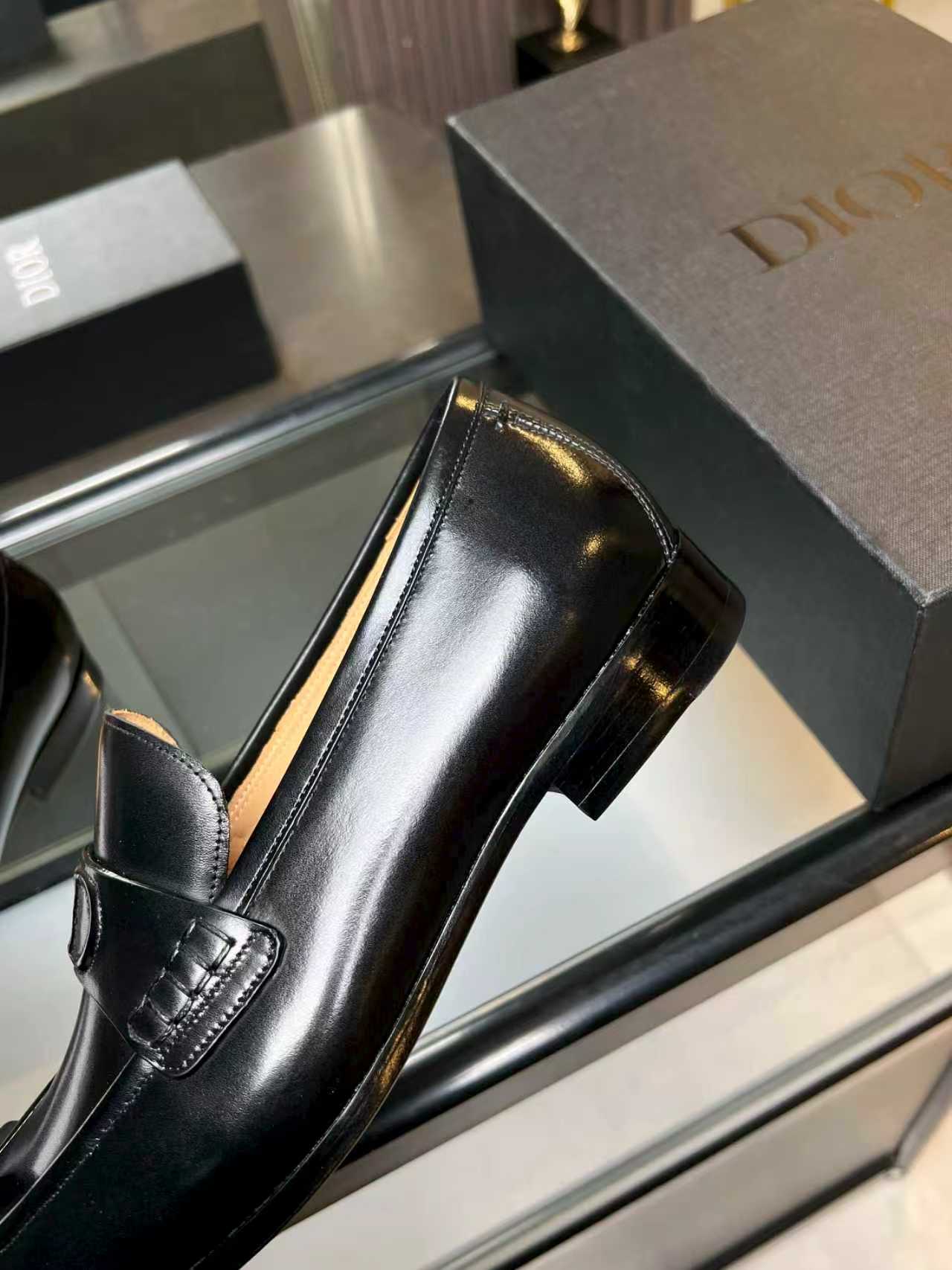 Black leather dress loafer with Dior monogram buckle, close side view