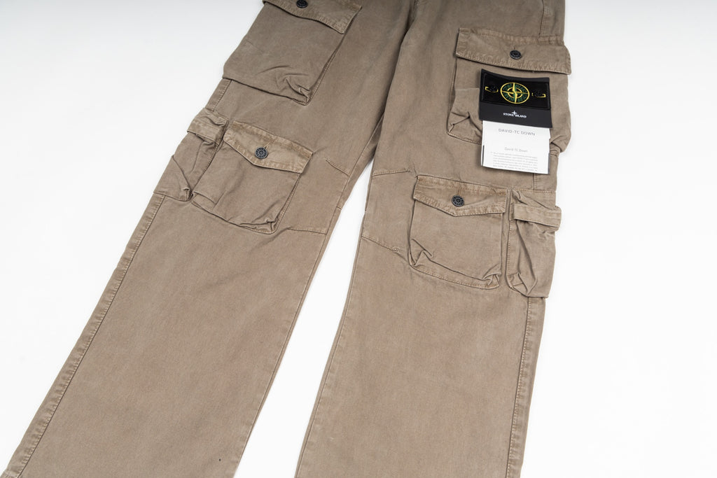 Tan cargo pants close-up with front flap pockets and brand tag on waistband