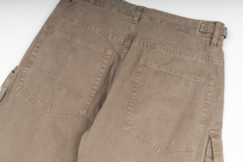 Tan cargo pants back pocket area with stitched details and reinforced seams