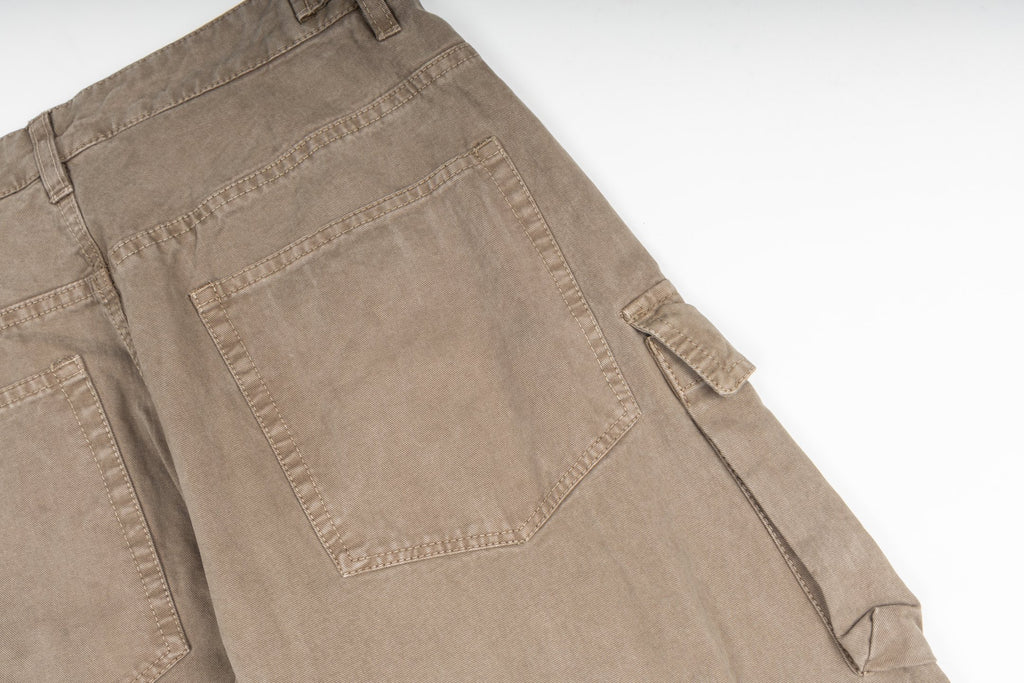 Tan cargo pants close-up showing large back pocket and side pocket flap
