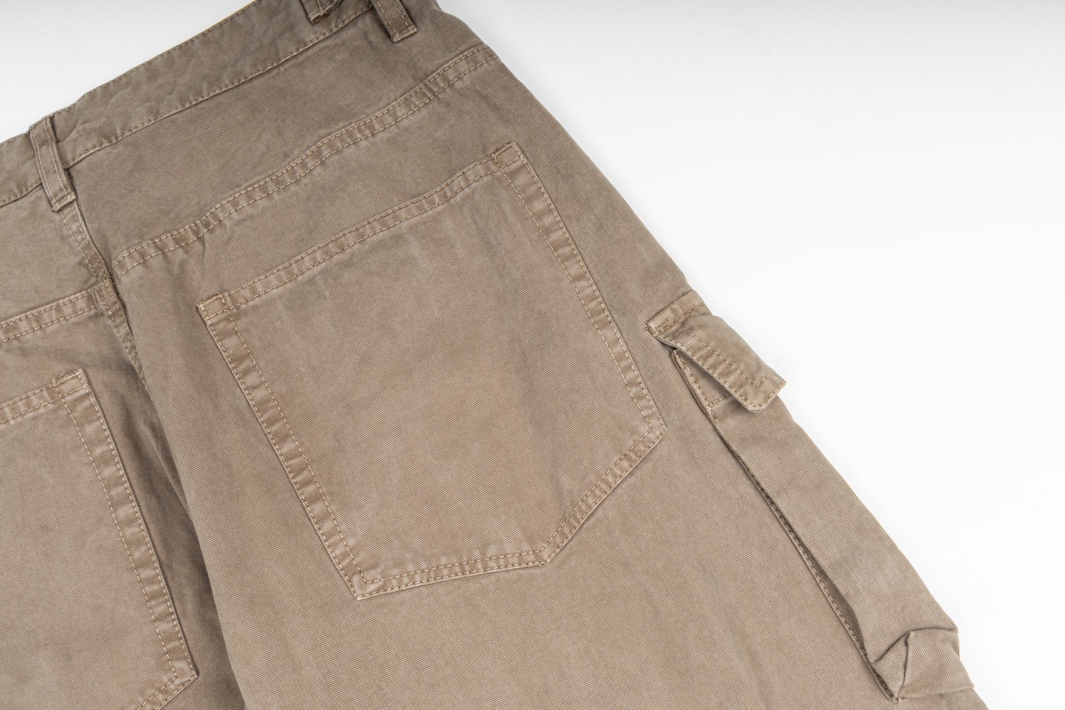 Tan cargo pants close-up showing large back pocket and side pocket flap