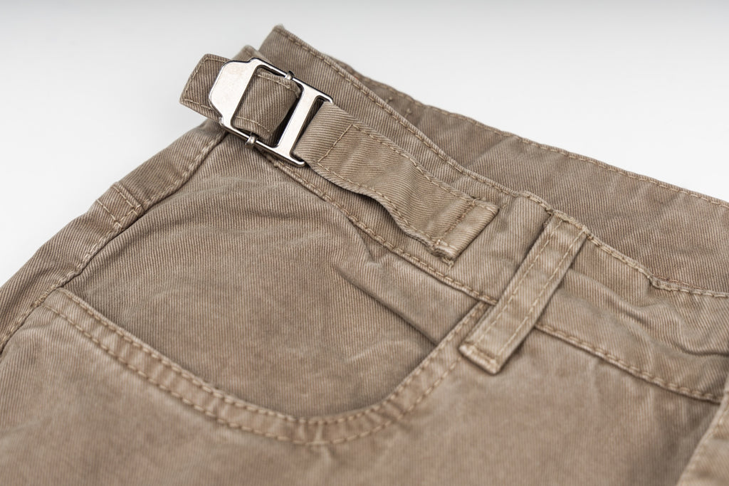 Tan cargo pants waistband detail with belt loops and buttoned closure