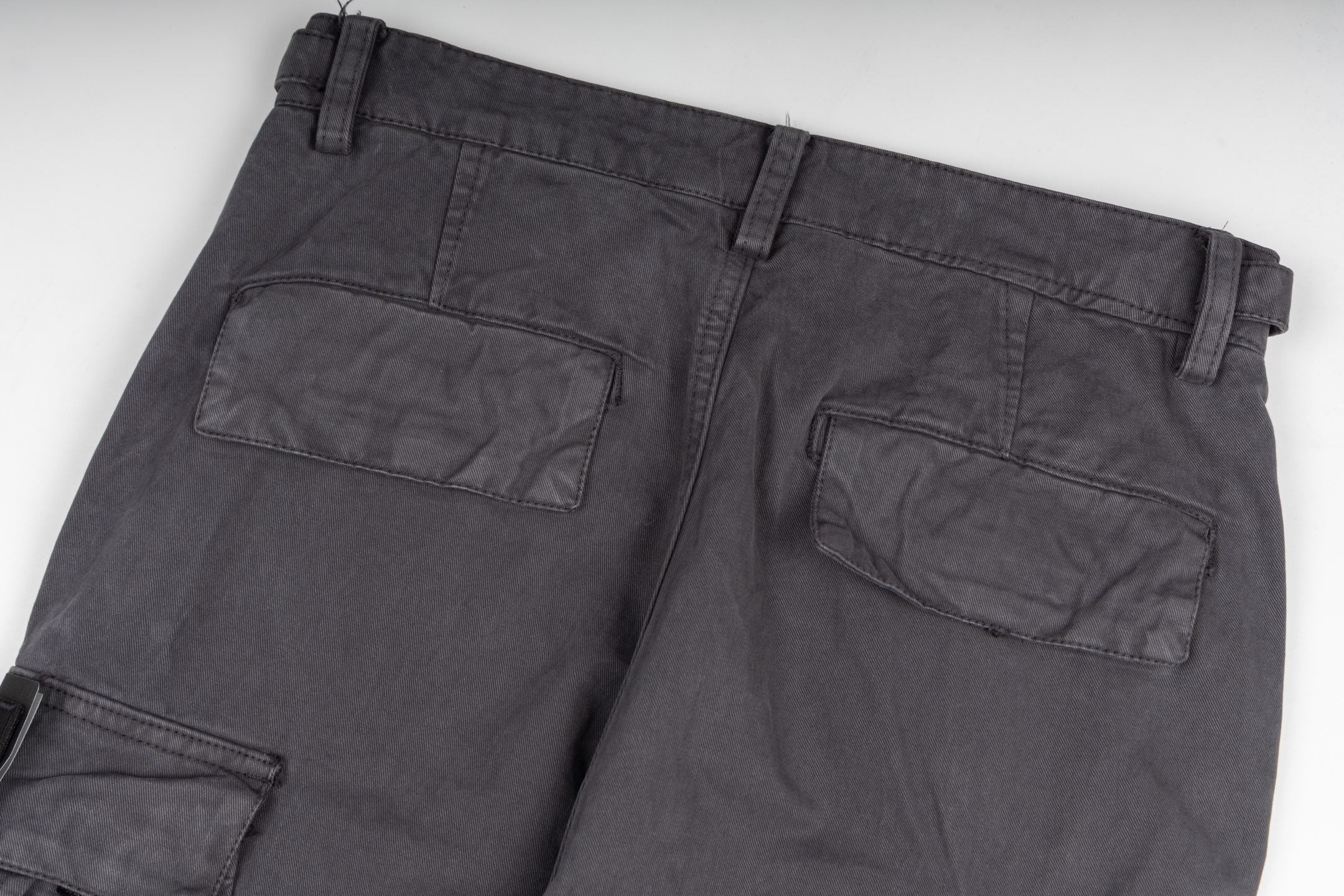 Stone Island cargo pants close-up of front pockets, dark gray