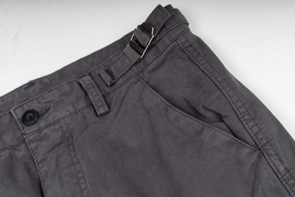 Stone Island cargo pants front view, dark gray with button and zipper placket