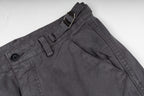 Stone Island cargo pants front view, dark gray with button and zipper placket