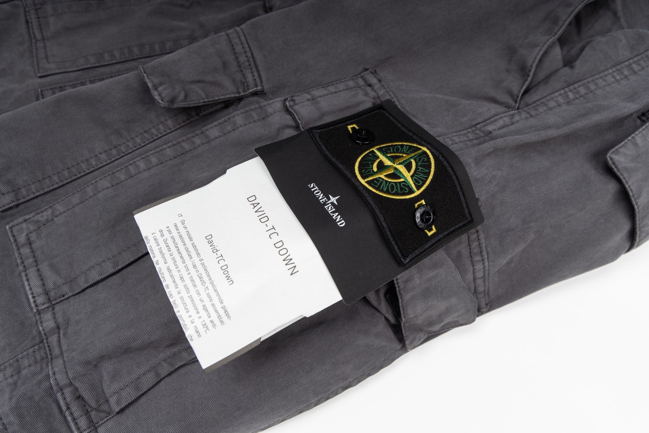 Stone Island cargo pants label and patch on dark gray fabric