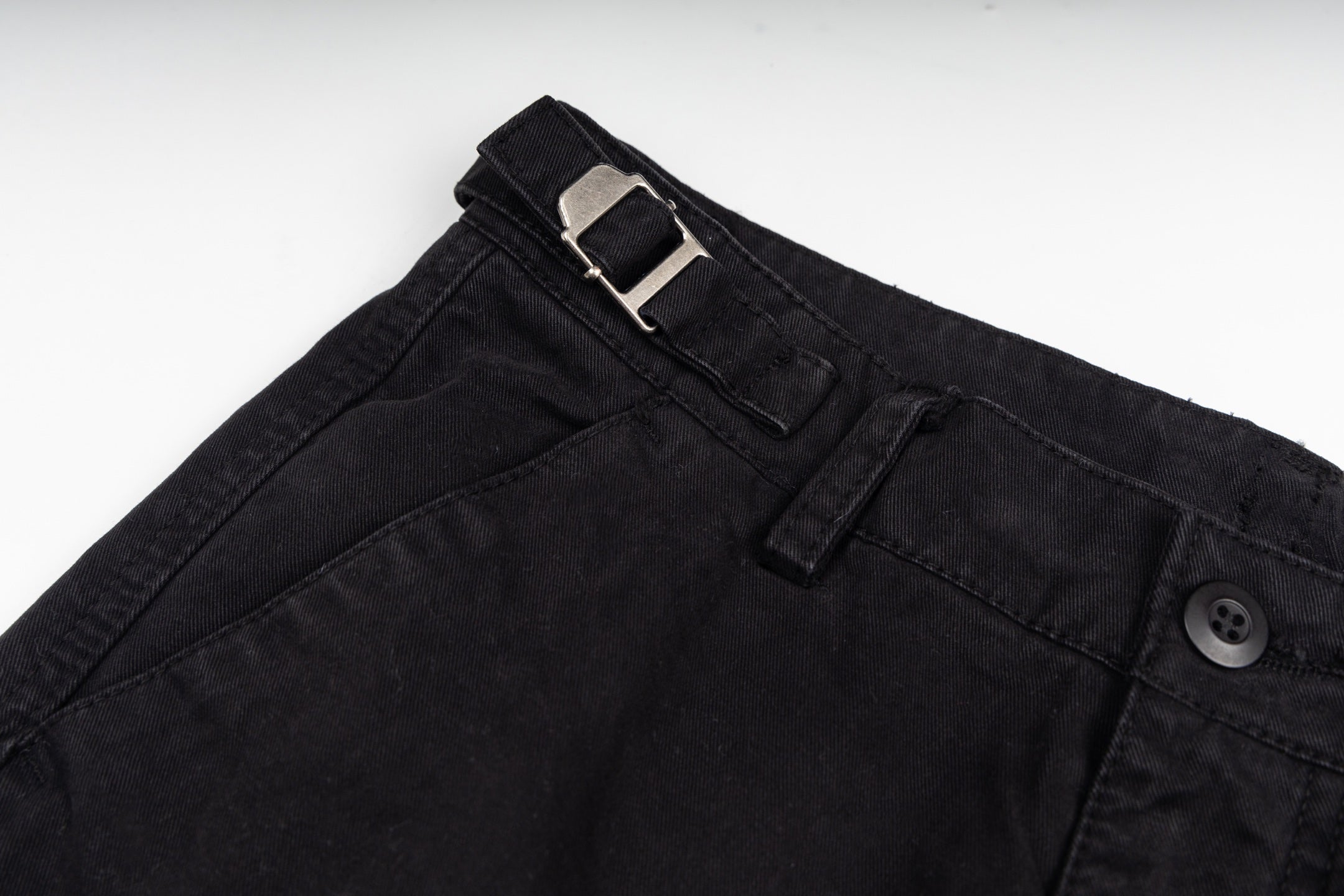 Black cargo trousers with metal buckle detail at waistband