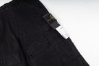 Black cargo trousers with brand tag on the pocket