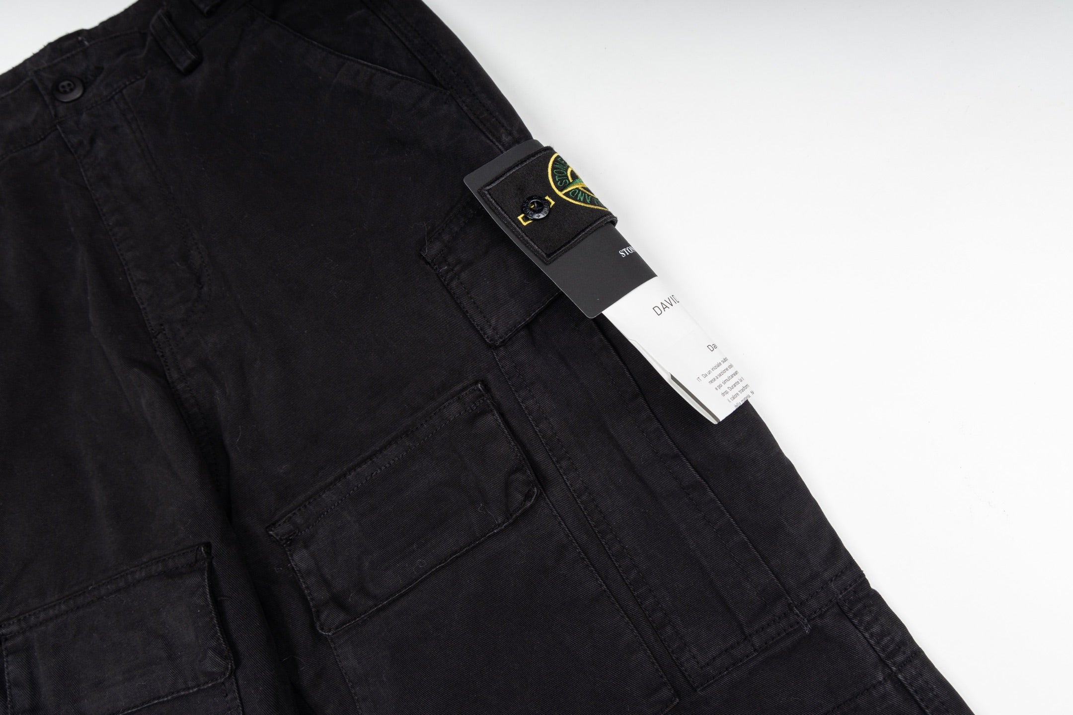 Black cargo trousers with brand tag on the pocket