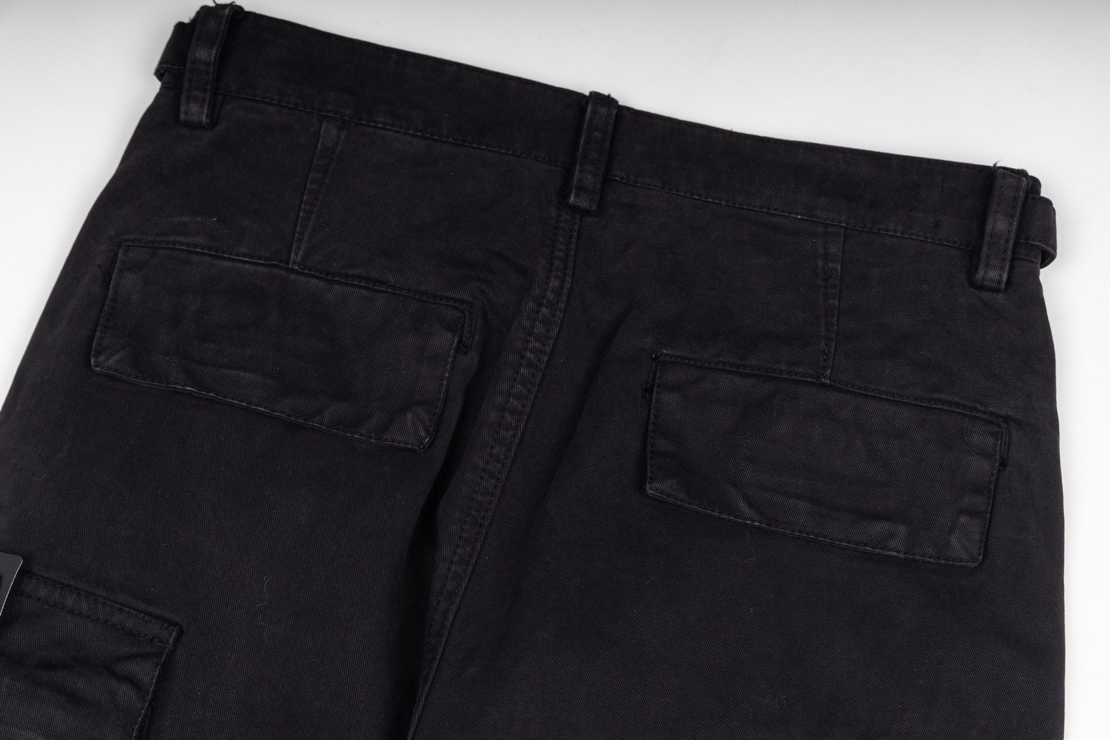 Black cargo trousers with front patch pockets and straight leg
