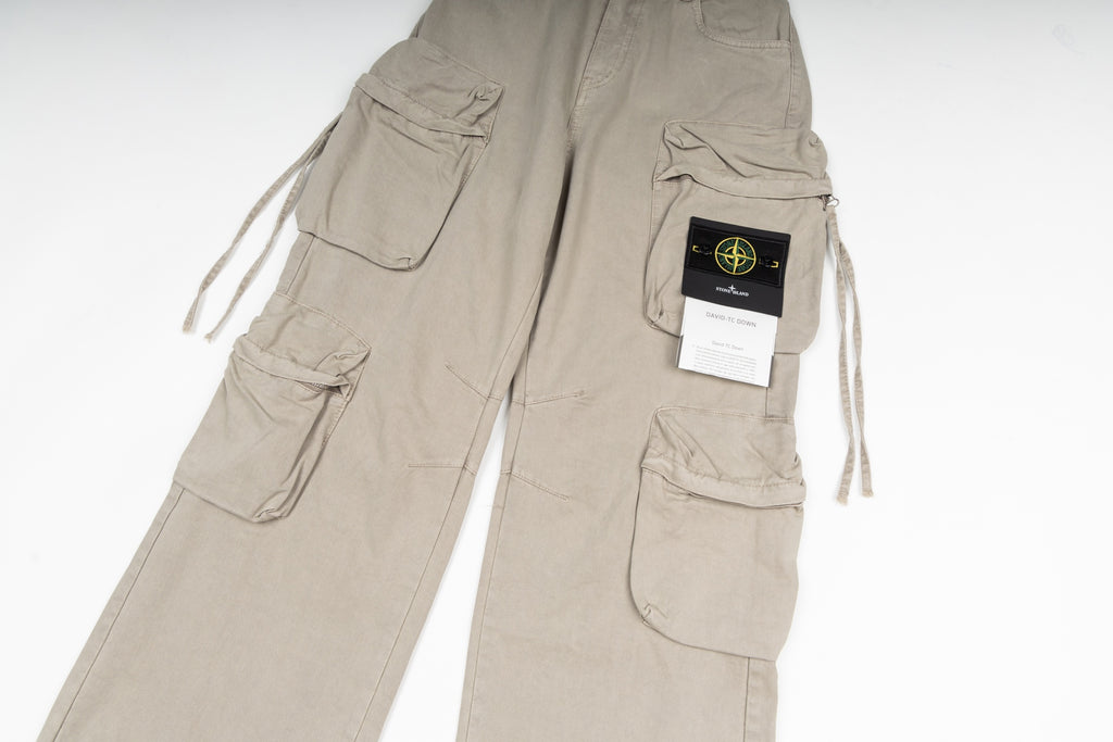 Stone Island cargo pants in sand, close-up of cargo pockets and label