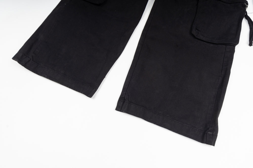 Stone Island cargo pants in black, close-up of hem and cargo pocket