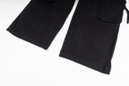 Stone Island cargo pants in black, close-up of hem and cargo pocket