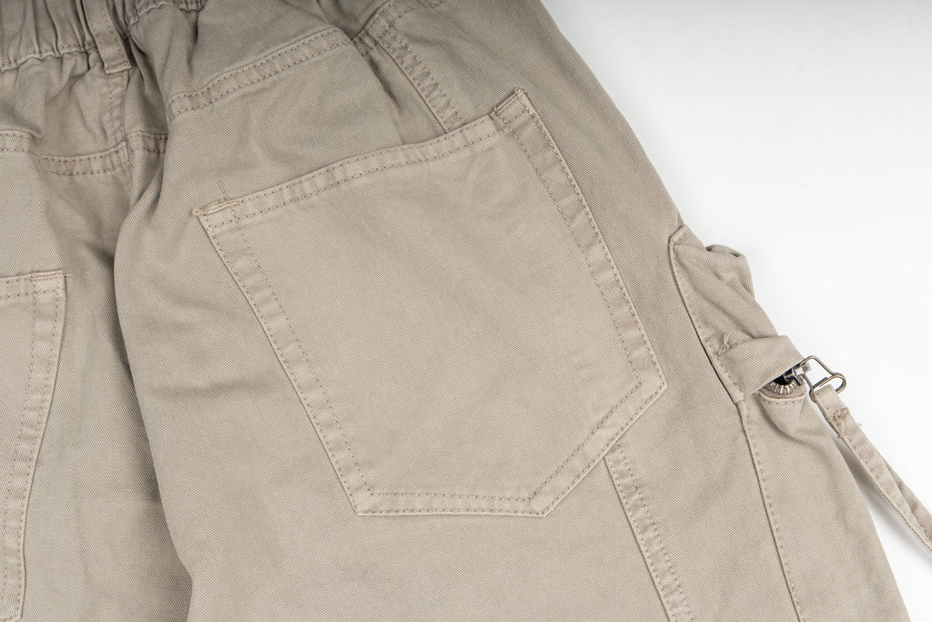 Stone Island cargo pants in sand, close-up of flap cargo pocket detail