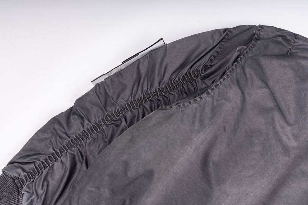 Dark gray bomber jacket with elasticized back hem and ribbed neckline