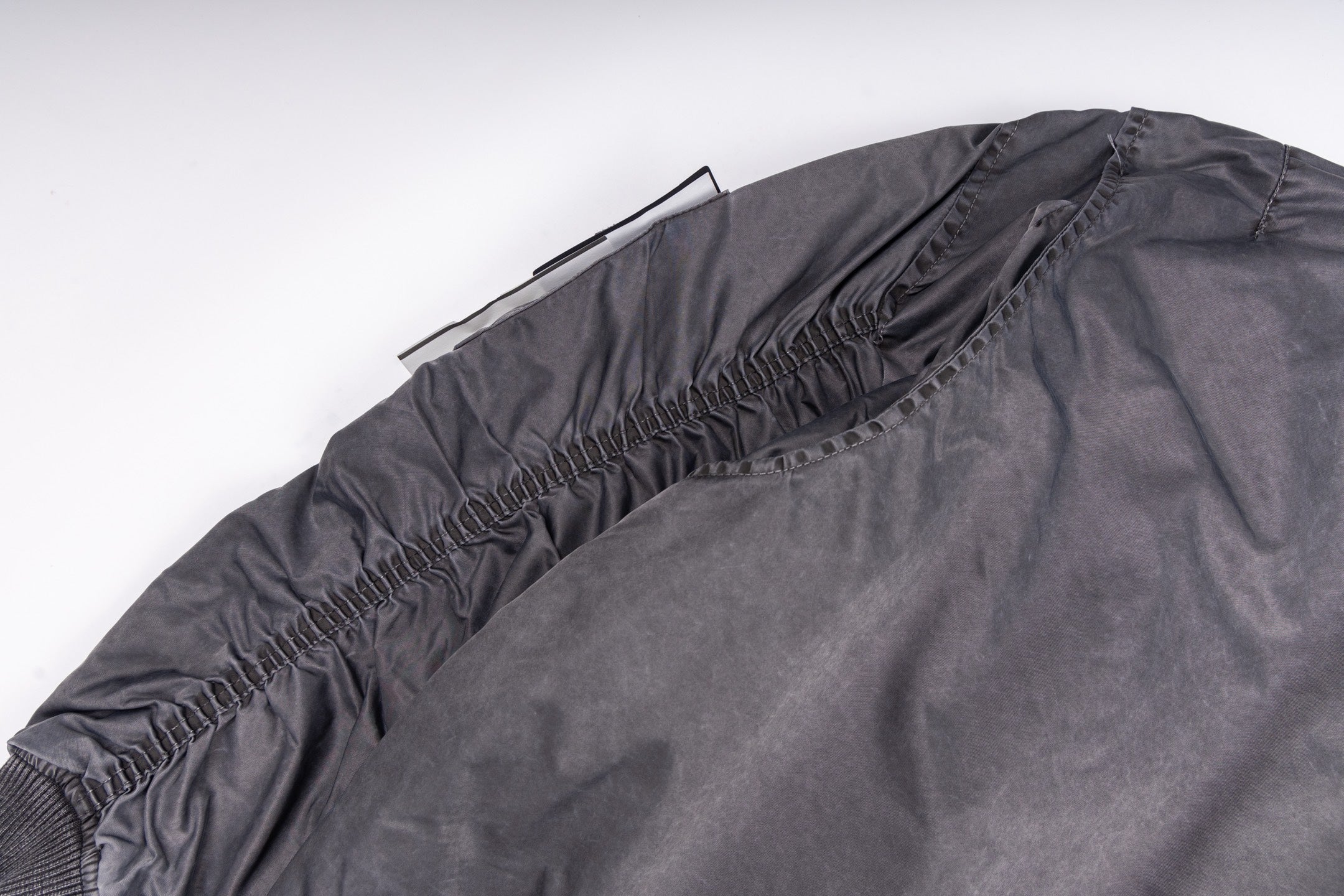 Dark gray bomber jacket with elasticized back hem and ribbed neckline