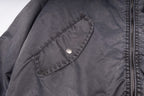 Dark gray bomber jacket with snap chest pocket and zipper track detail