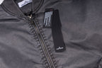 Stone Island zip-up jacket with dark zipper and logo patch, close-up neckline