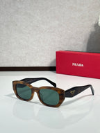 Prada sunglasses with tortoise-style frame and dark green lenses, side logo.