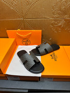 Hermes slide sandals with gray logo-pattern straps and black slip-on sole